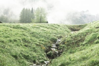 small creek on hill in mountains