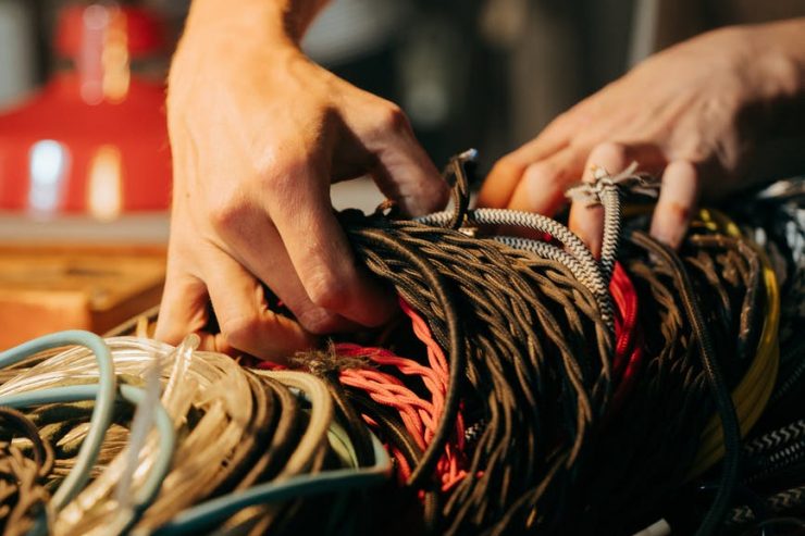 person holding brown and black rope